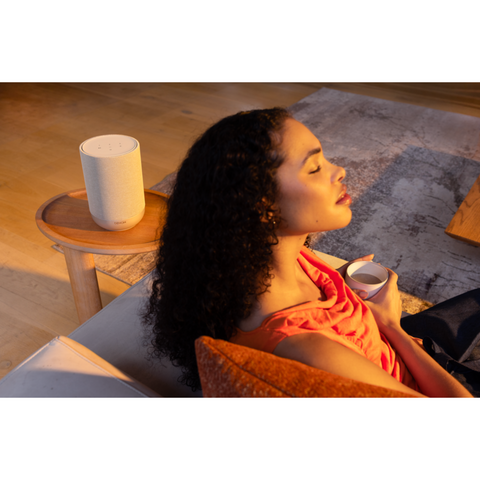 Denon Home 200 Wireless Smart Speaker listening on couch (view 5 of 6)