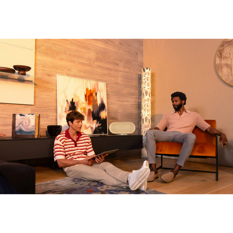 Denon Home 600 Wireless Smart Speaker two friends sitting in front of speaker (view 5 of 6)