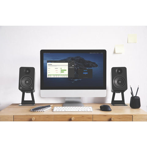 Kanto SE4 Speaker Stands - Black Pair Lifestyle Image of speakers on desk (view 7 of 10)
